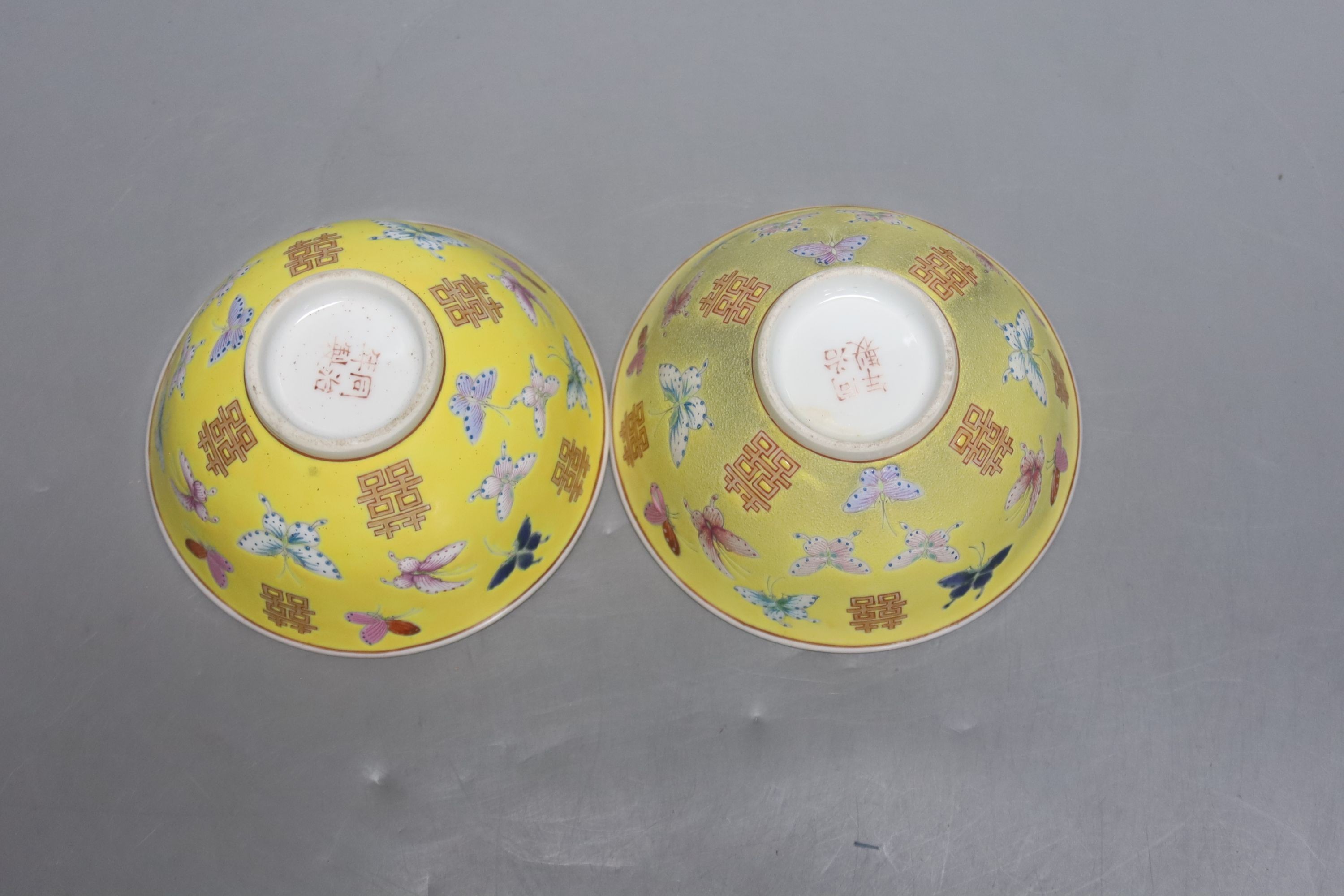 A pair of Chinese yellow ground porcelain small bowls, enamelled with butterflies, diameter 11cm